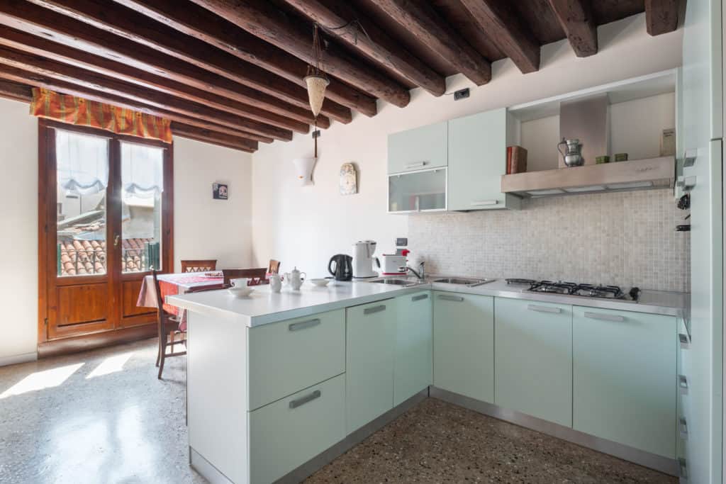 Large kitchen with modern furnishing and view on the terrace - Ca' Coriandolo Apartment Large kitchen with modern furnishing and view on the terrace - Ca' Coriandolo Apartment