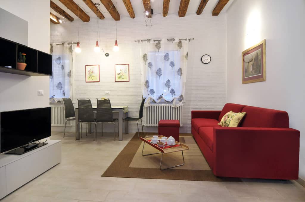 Large dining and living room with modern furnishing - Ca' Dorina Apartment Large dining and living room with modern furnishing - Ca' Dorina Apartment