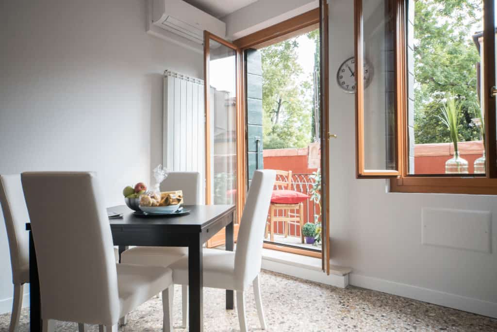 Detail of the dining table with view on the terrace - Venier Apartment Detail of the dining table with view on the terrace - Venier Apartment