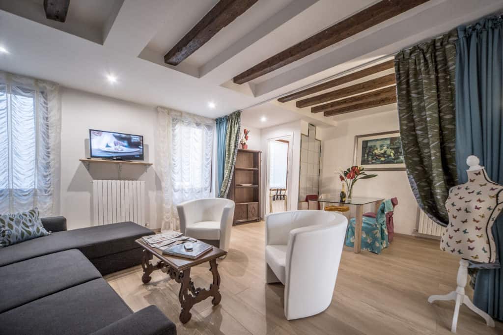 RIght view of the small living room with curtains and modern furnishing - Ca' Alba Apartment- Ca' Alba Apartment RIght view of the small living room with curtains and modern furnishing - Ca' Alba Apartment- Ca' Alba Apartment