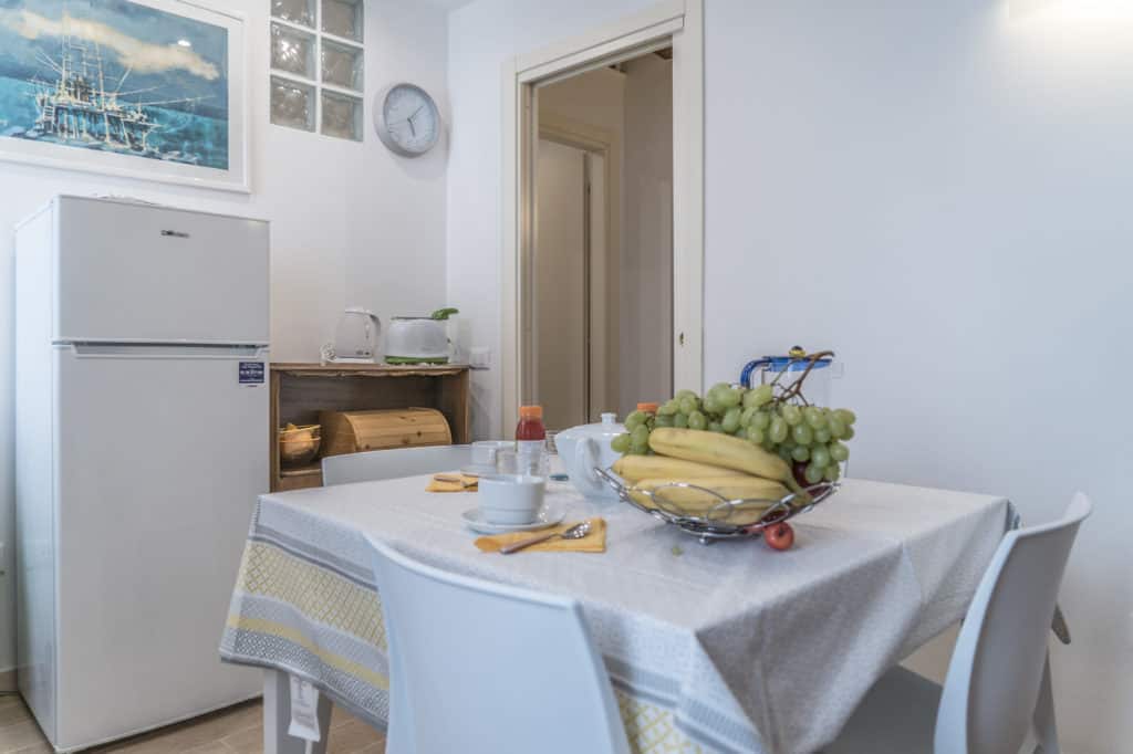 Entrance door of the small kitchen with fridge - Ca' Alba Apartment Entrance door of the small kitchen with fridge - Ca' Alba Apartment