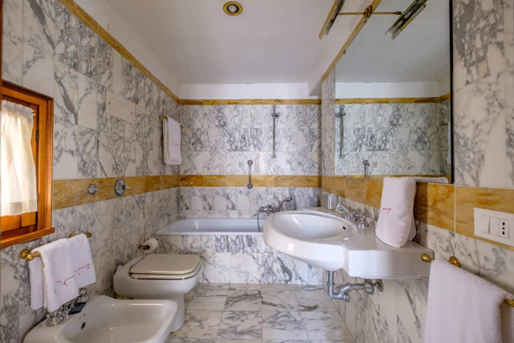 Large bathroom with bathtub, marbled walls and floor- Casa dell'Albero Apartment Large bathroom with bathtub, marbled walls and floor- Casa dell'Albero Apartment