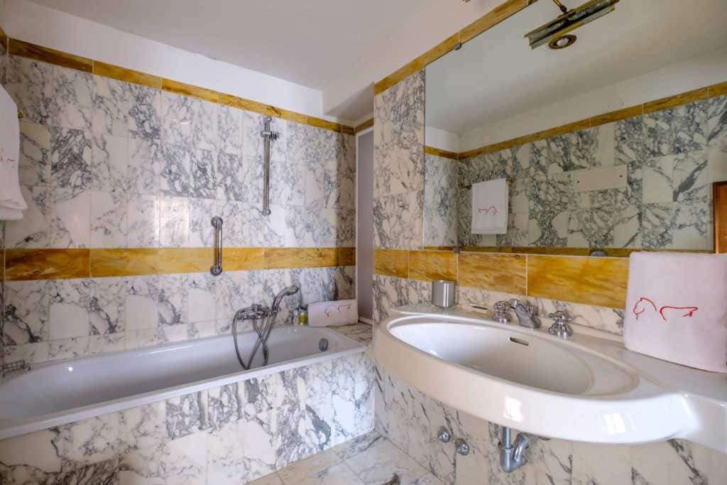 Bathroom with marbled bathtub and walls - Casa dell'Albero Apartment Bathroom with marbled bathtub and walls - Casa dell'Albero Apartment