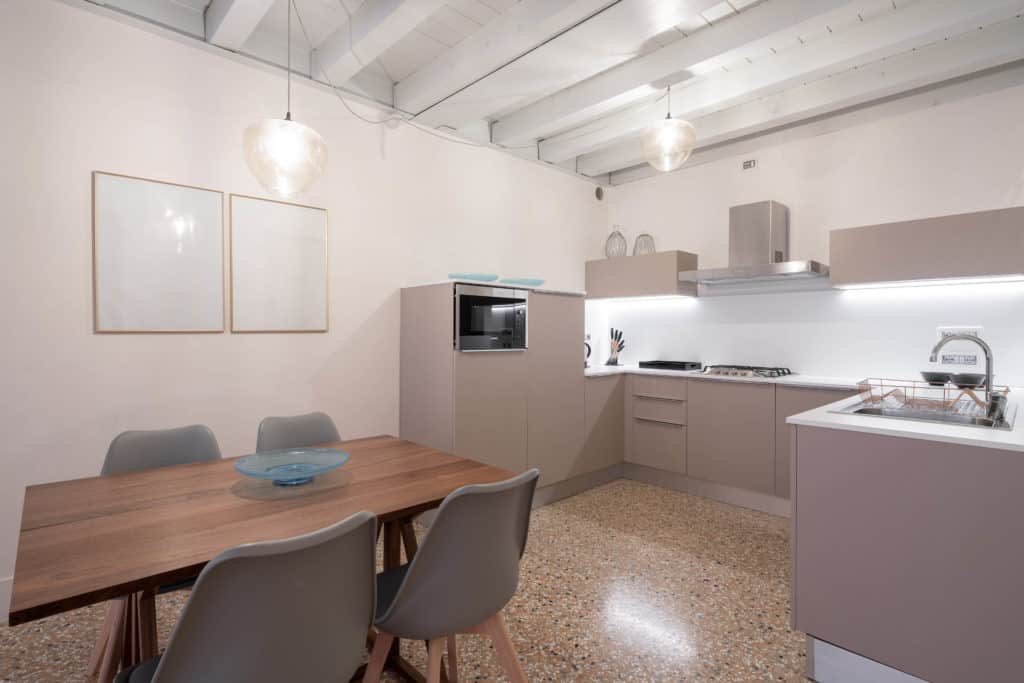 Left view of the large open air kitchen and dining area with mod Left view of the large open air kitchen and dining area with modern furnishing - Palazzo Molin Massari Apartment