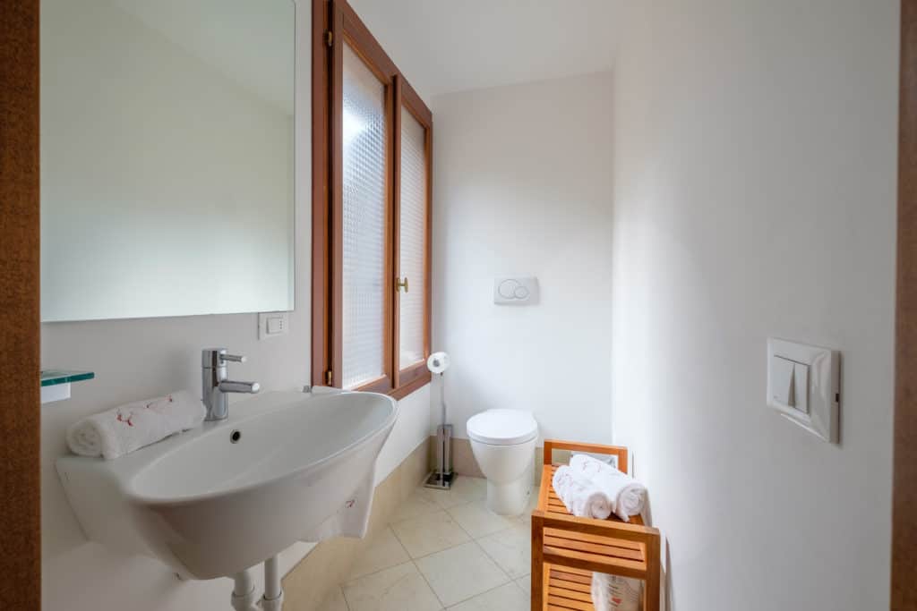 Small bathroom with large window - The Lion's 3 Apartment Small bathroom with large window - The Lion's 3 Apartment