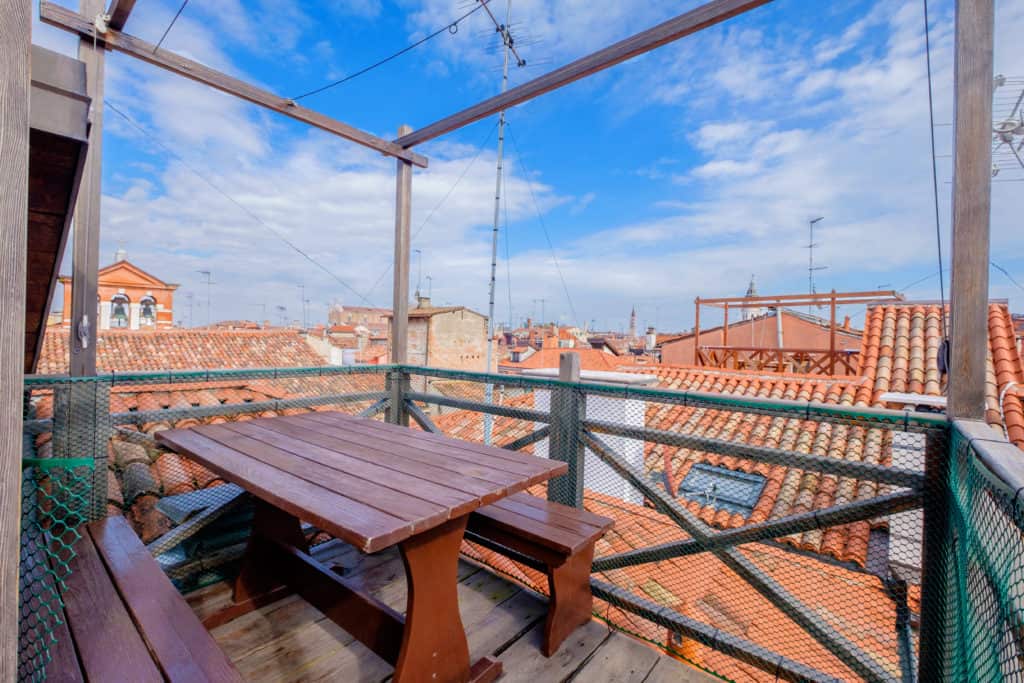 Dining table on the small terrace with panoramic view of the Venetian roofs - The Lion's 4 Apartment Dining table on the small terrace with panoramic view of the Venetian roofs - The Lion's 4 Apartment