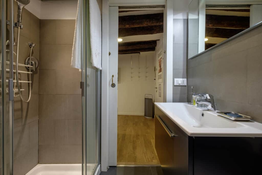 Left view of the small bathroom with modern furnishing - The Lion's 5 Apartment Left view of the small bathroom with modern furnishing - The Lion's 5 Apartment