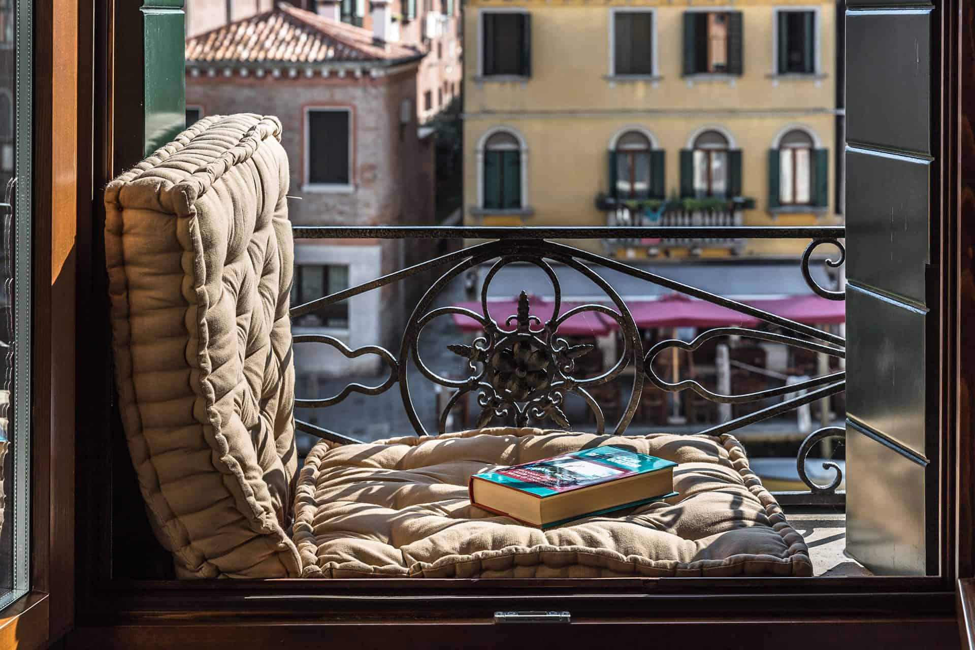 Typical Venetian balcony with a book and view on the campo - Rental Apartment in Venice